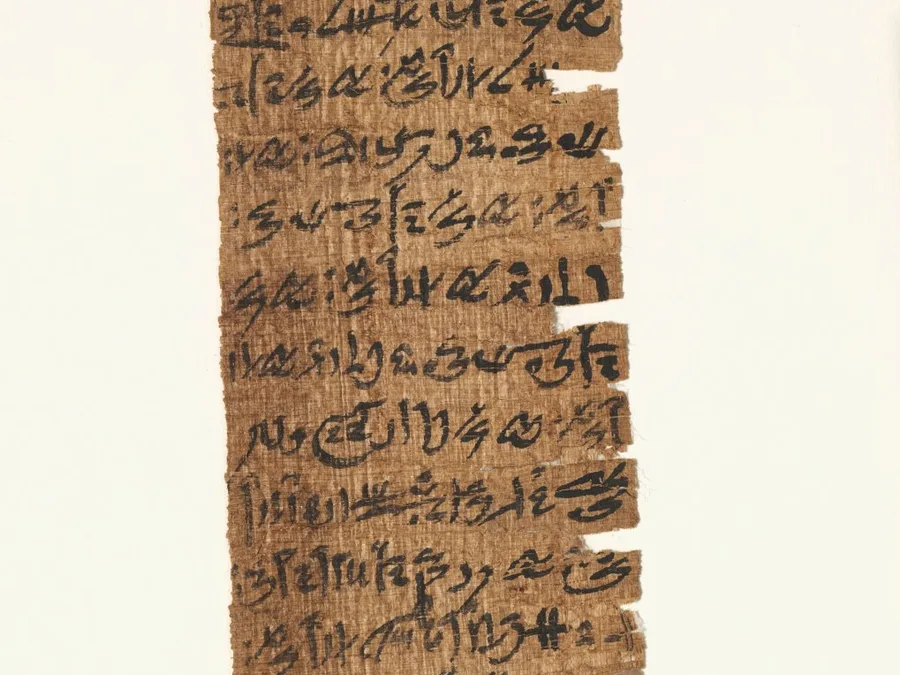 Narrow Egyptian papyrus amuletic decree with written text.