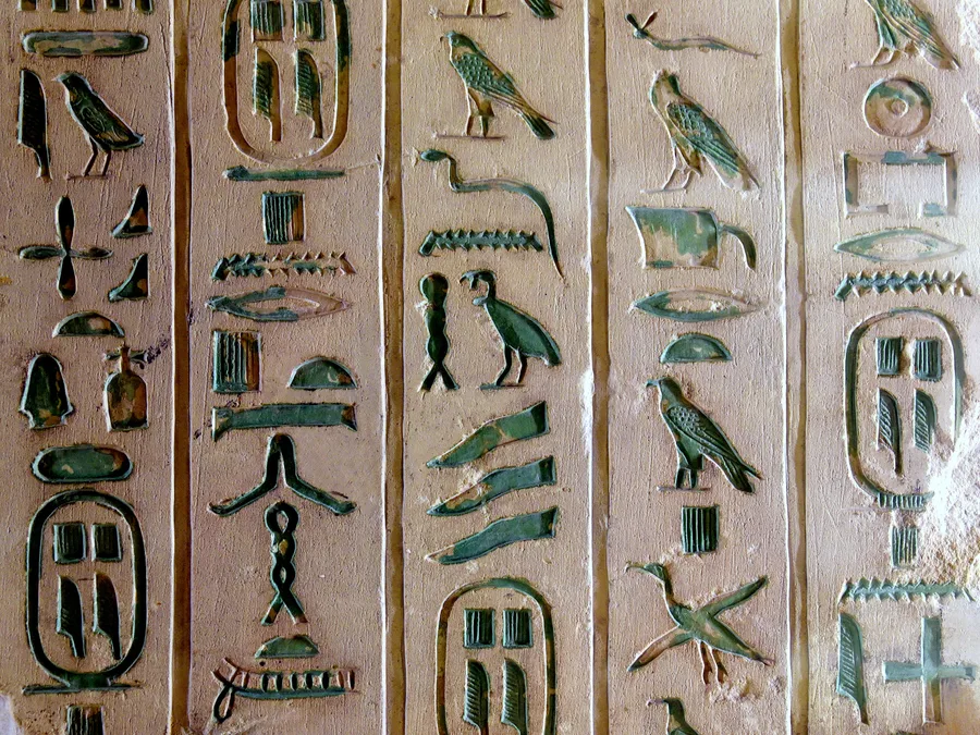 Limestone fragment with green Egyptian hieroglyphic Pyramid Texts and cartouches of Pepi I.