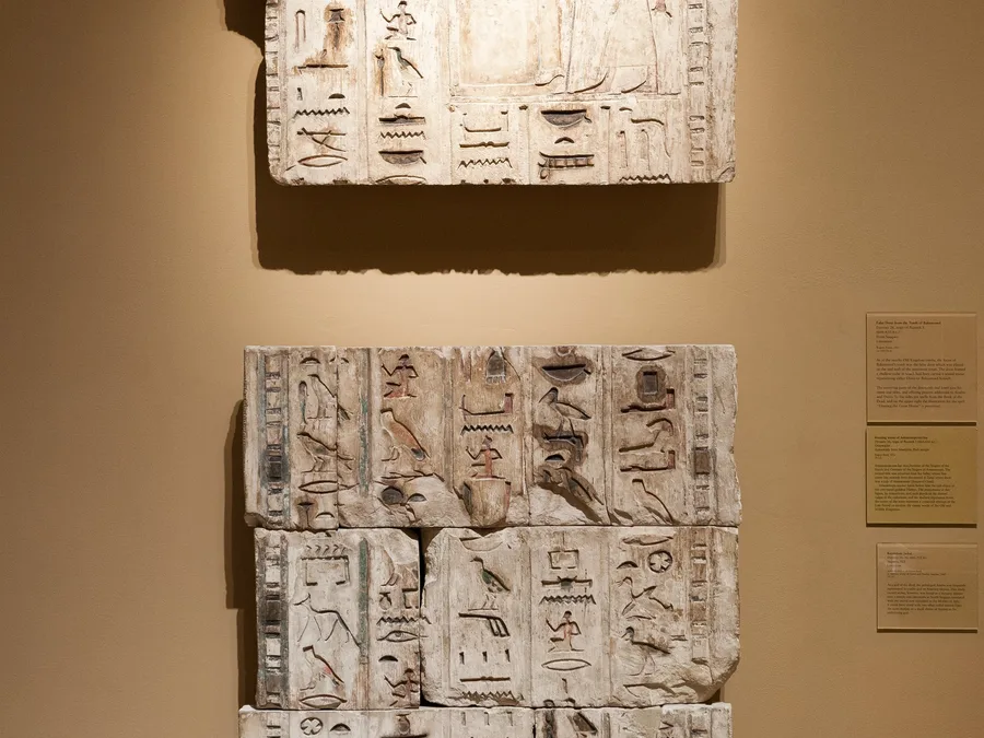 Egyptian false-door relief sections from the tomb of Bakenrenef with hieroglyphic inscriptions.