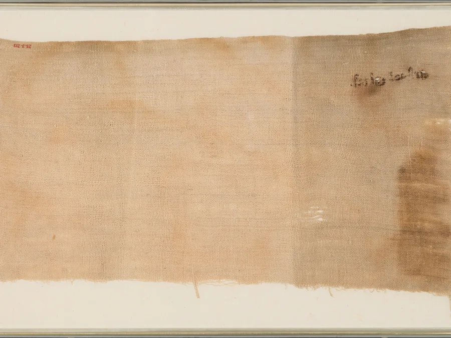 Egyptian mummy cloth fragment with inscription traces.