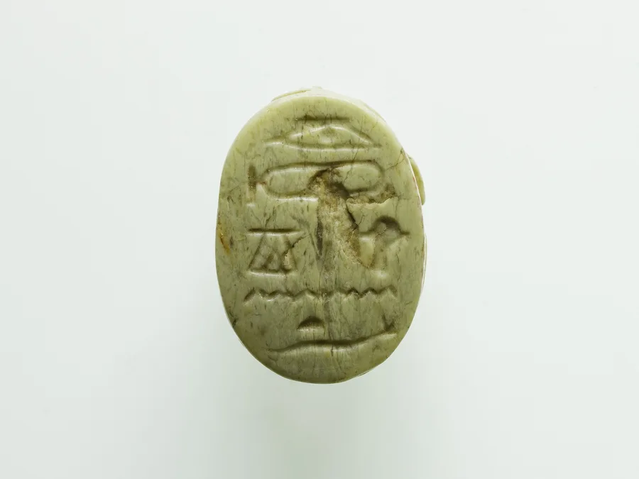 Egyptian scarab with hieroglyphic inscription referring to Osiris.